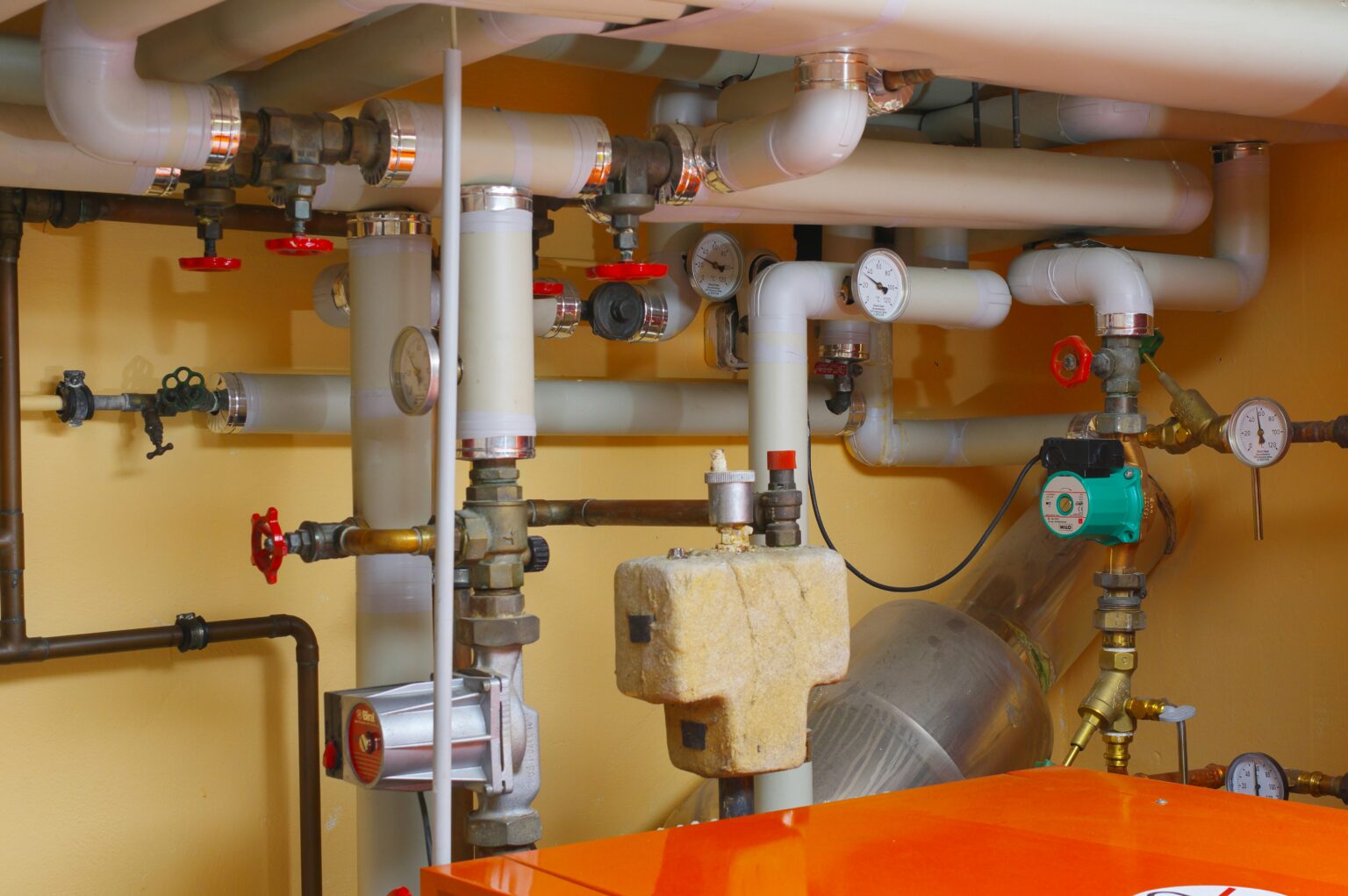 Pipes, valves, and gauges in a plumbing system, illustrating essential components for heating and gas services relevant to bathroom refurbishment and emergency plumbing in Nottingham.